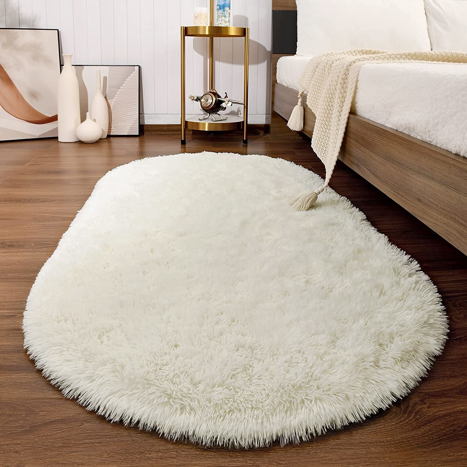 The rug in white next to a bed