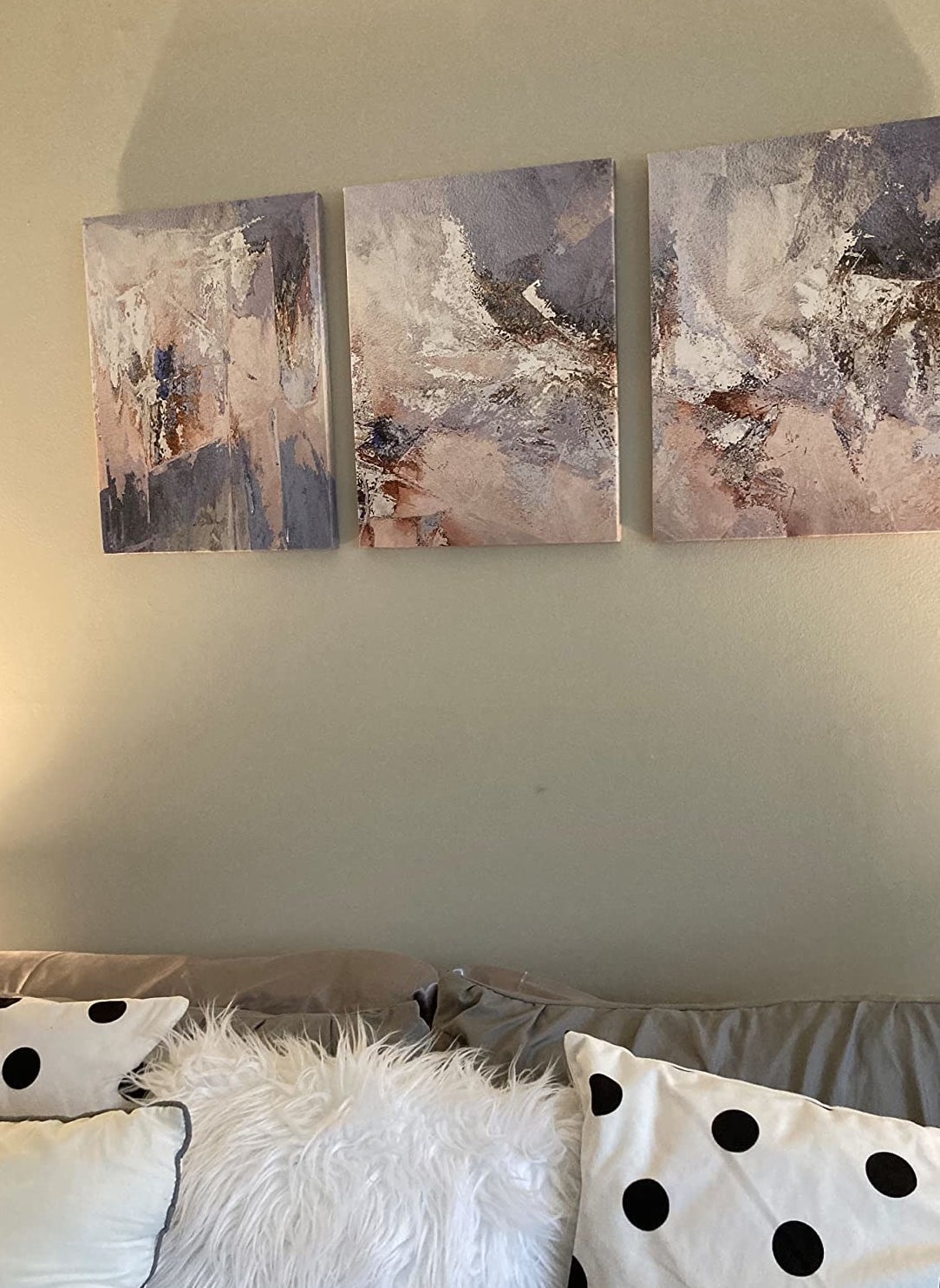 A reviewer&#x27;s photo of the canvases in the living room