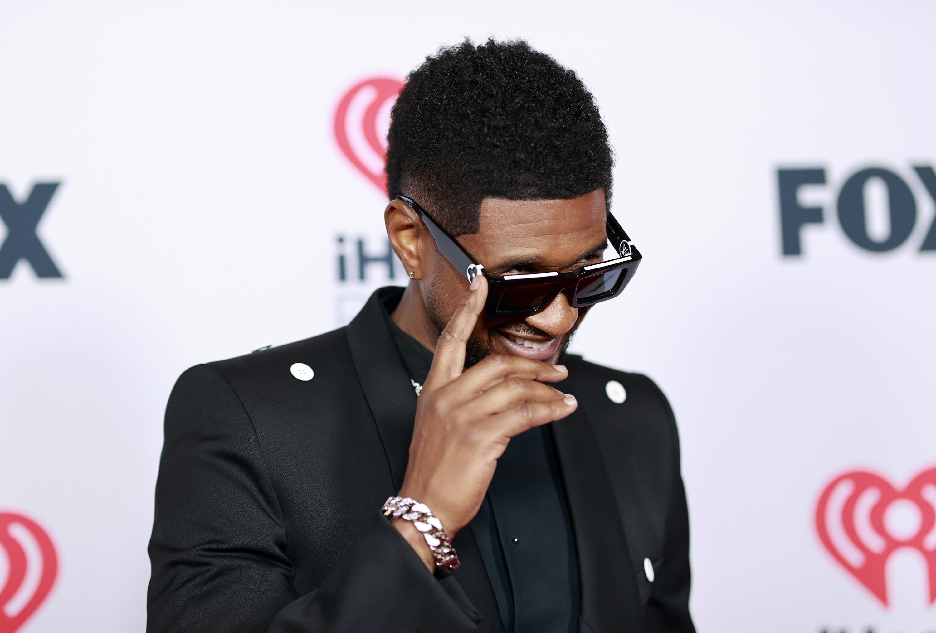 Usher being announced as the headline act for the Super Bowl halftime show  splits fans, as some call the 'Yeah!' hitmaker 'irrelevant' while others  describe him as 'iconic'