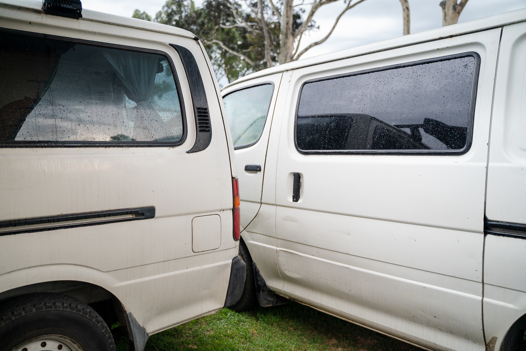 Photo of two vans parked very close together