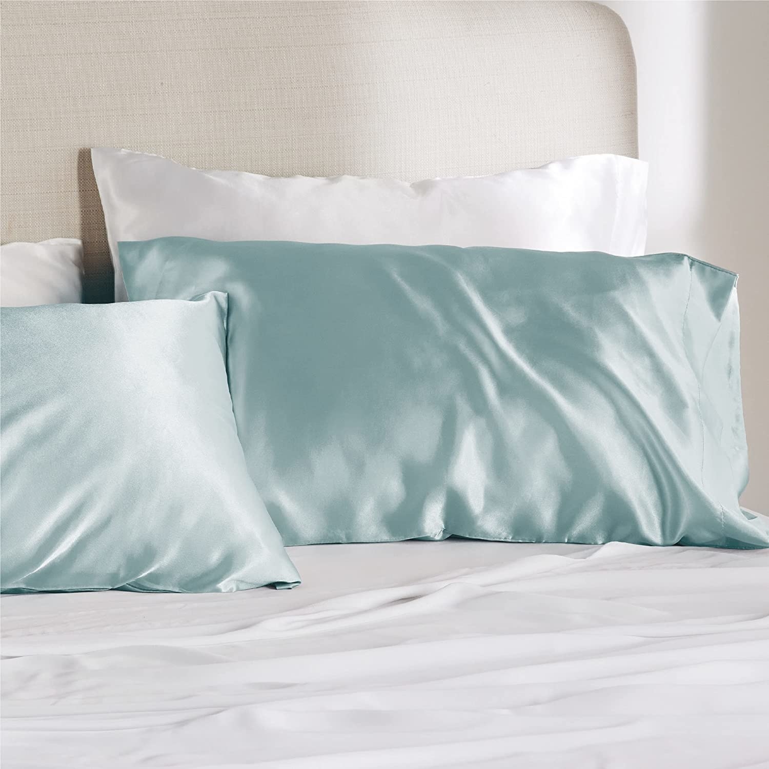 The pillowcases on a bed in light blue