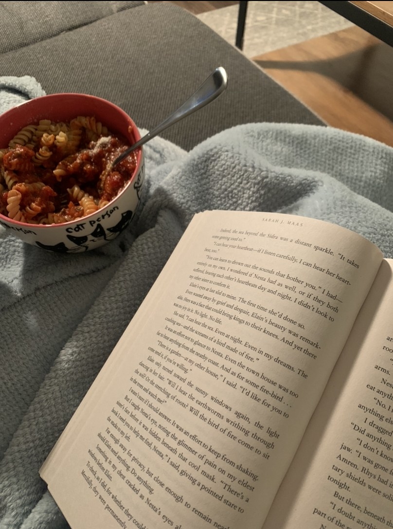 A bowl of pasta and a book