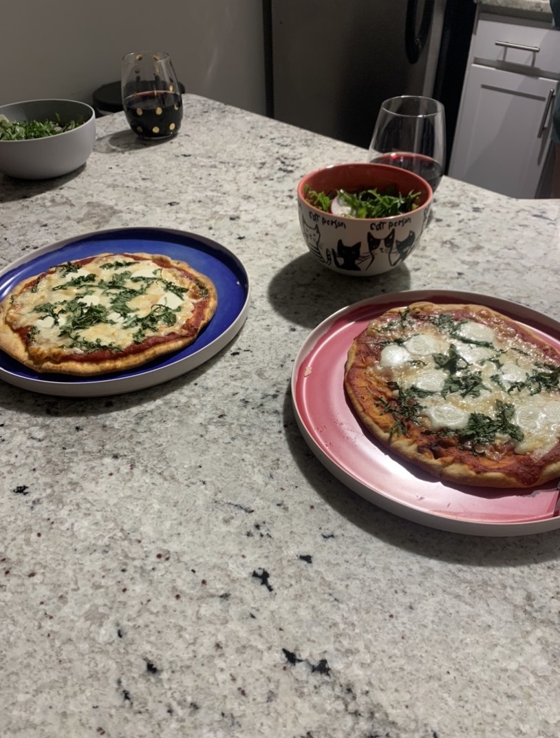 Homemade pizzas, salad, and wine