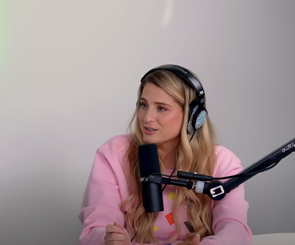 Meghan sitting in front of a studio microphone