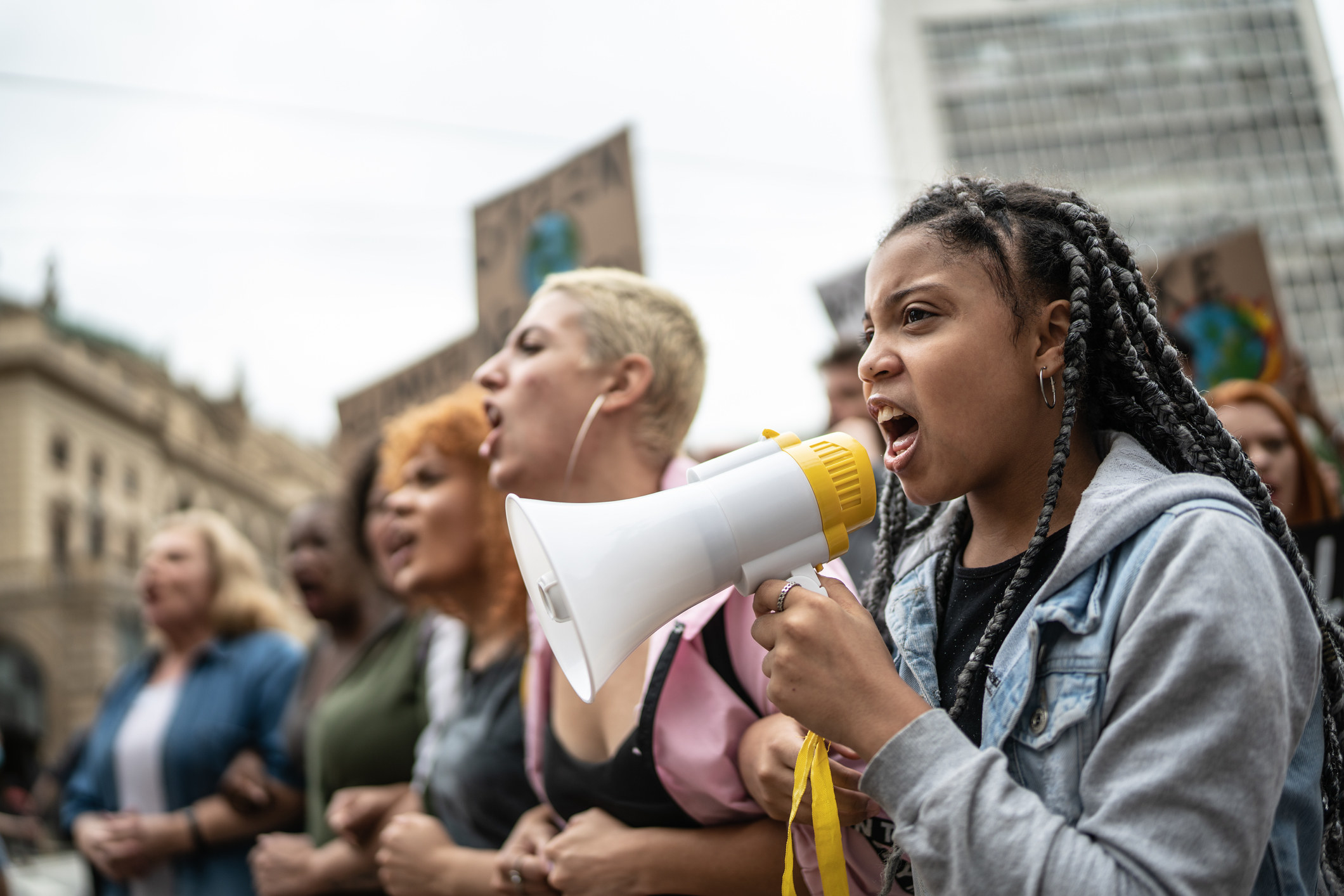 photo of young people an a protest, one with a megaphone