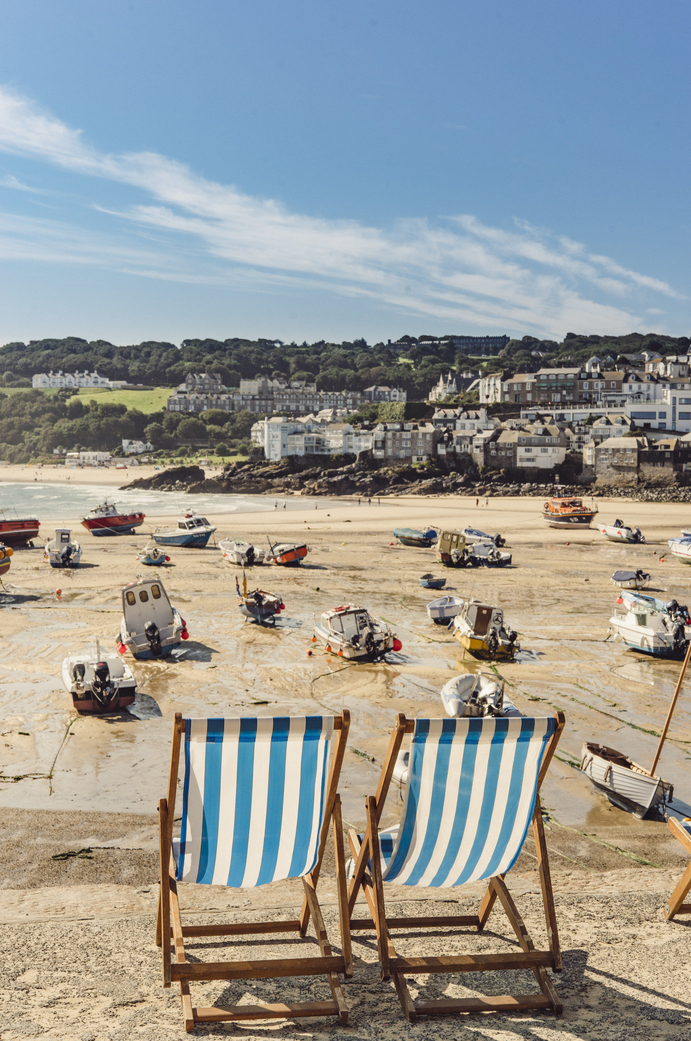 Empty deck chairs and boats along the St Ives beach in Cornwall.