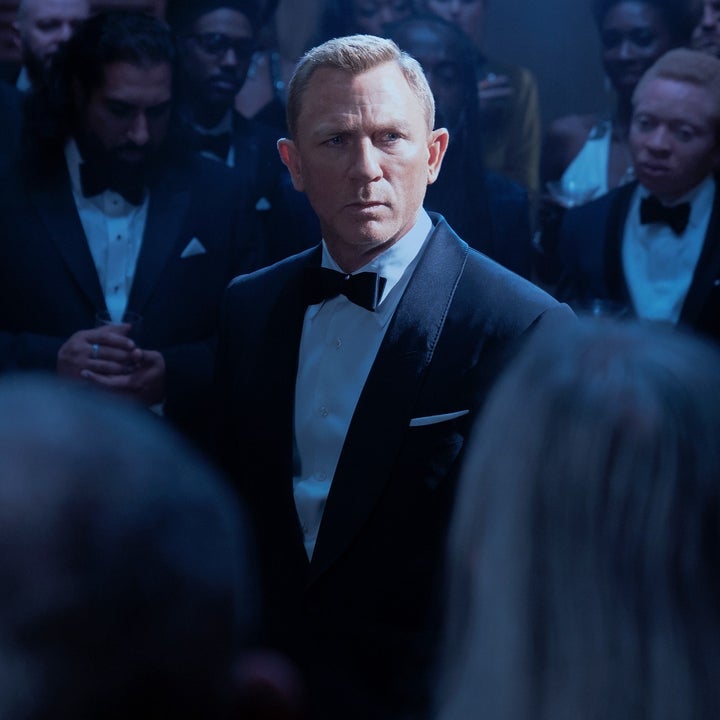 James Bond in a suit surrounded by people