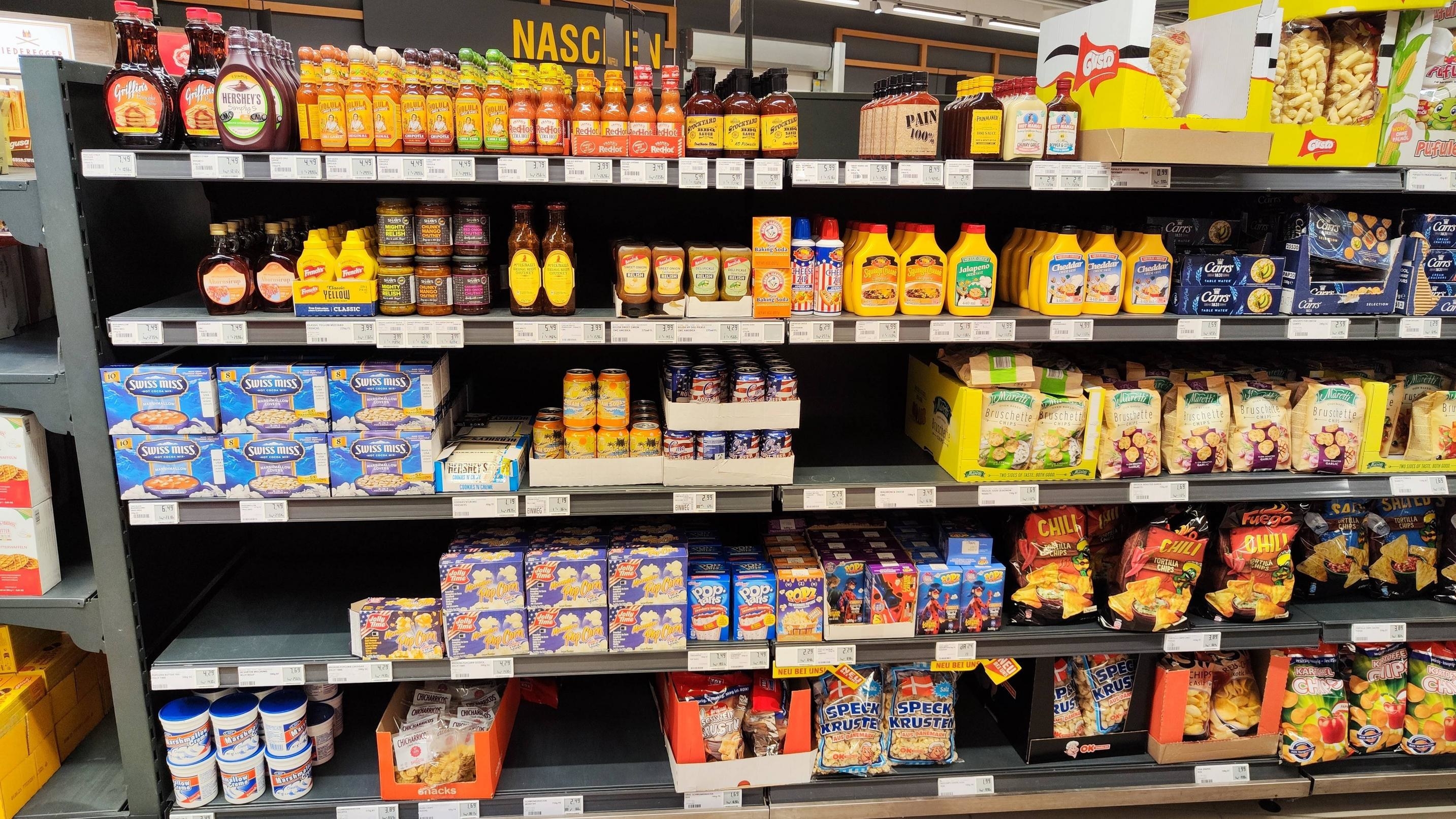 Shelves with popcorn, mustard, Pop-Tarts, and other American products