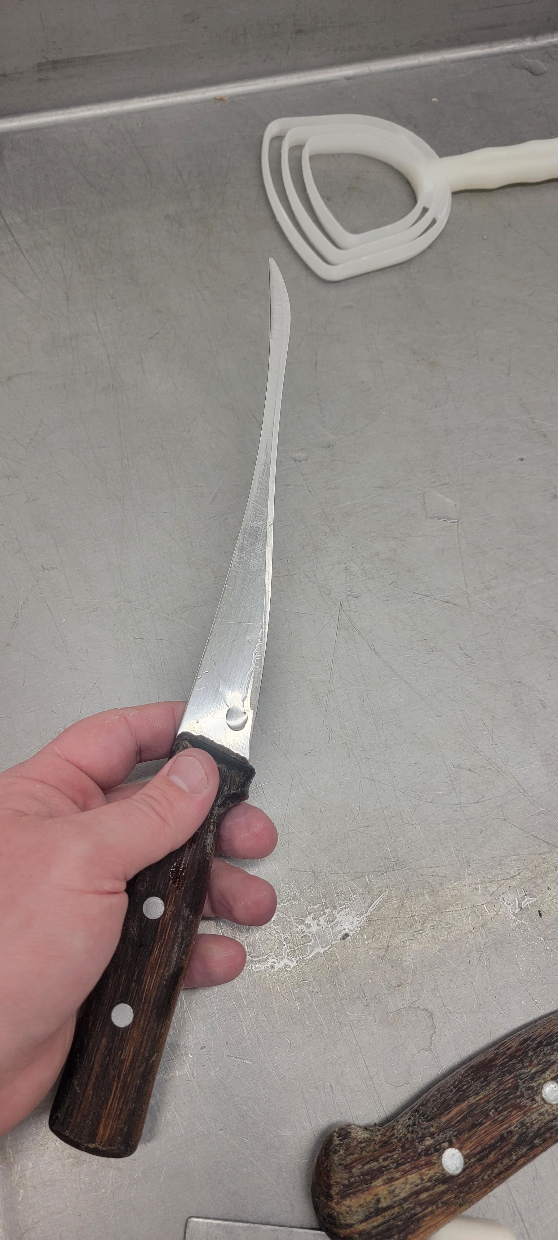 A very thin, elongated, tapered knife