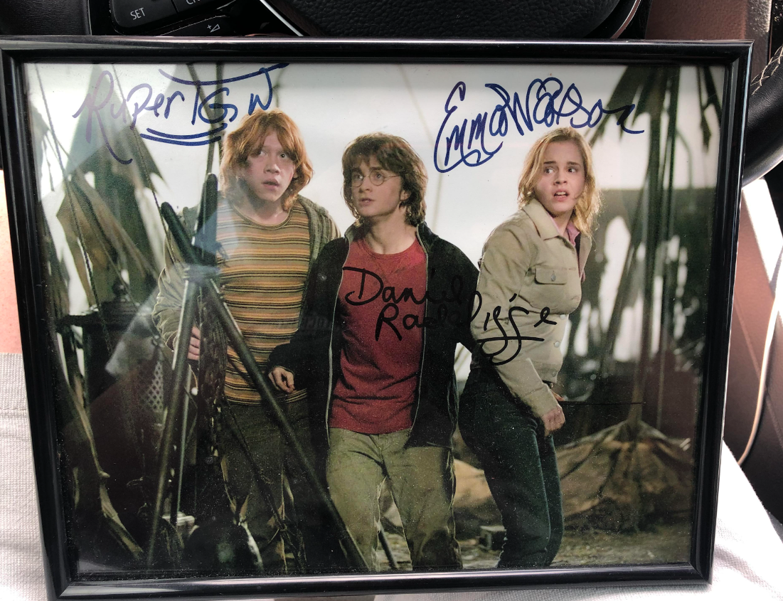 sign photo of harry, ron and hermoine from harry potter