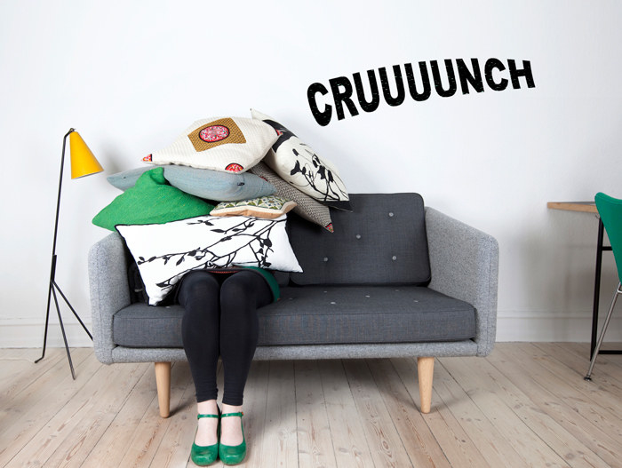 A person hidden beneath pillows with a large "crunch" in text onscreen