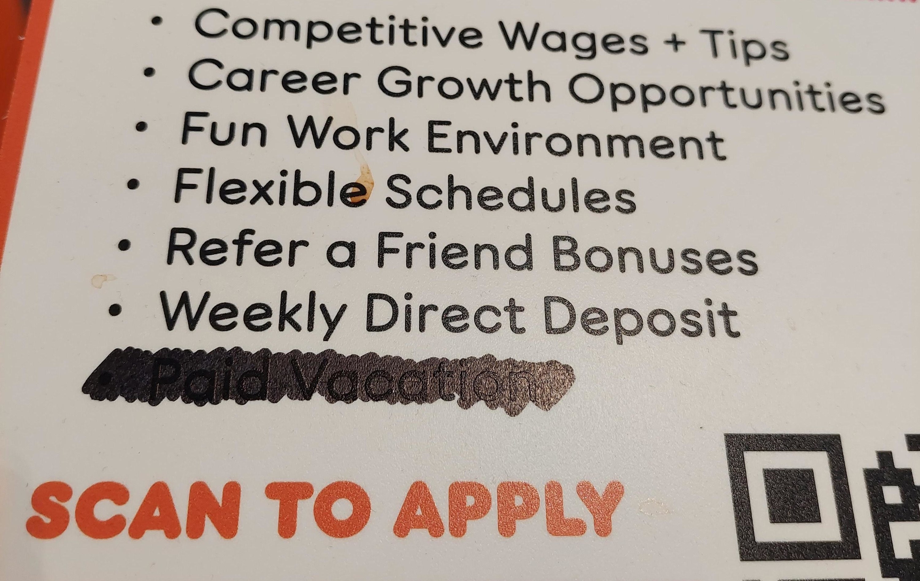 A &quot;We're Hiring&quot; sign listing employee benefits with &quot;paid vacation&quot; poorly scribbled out