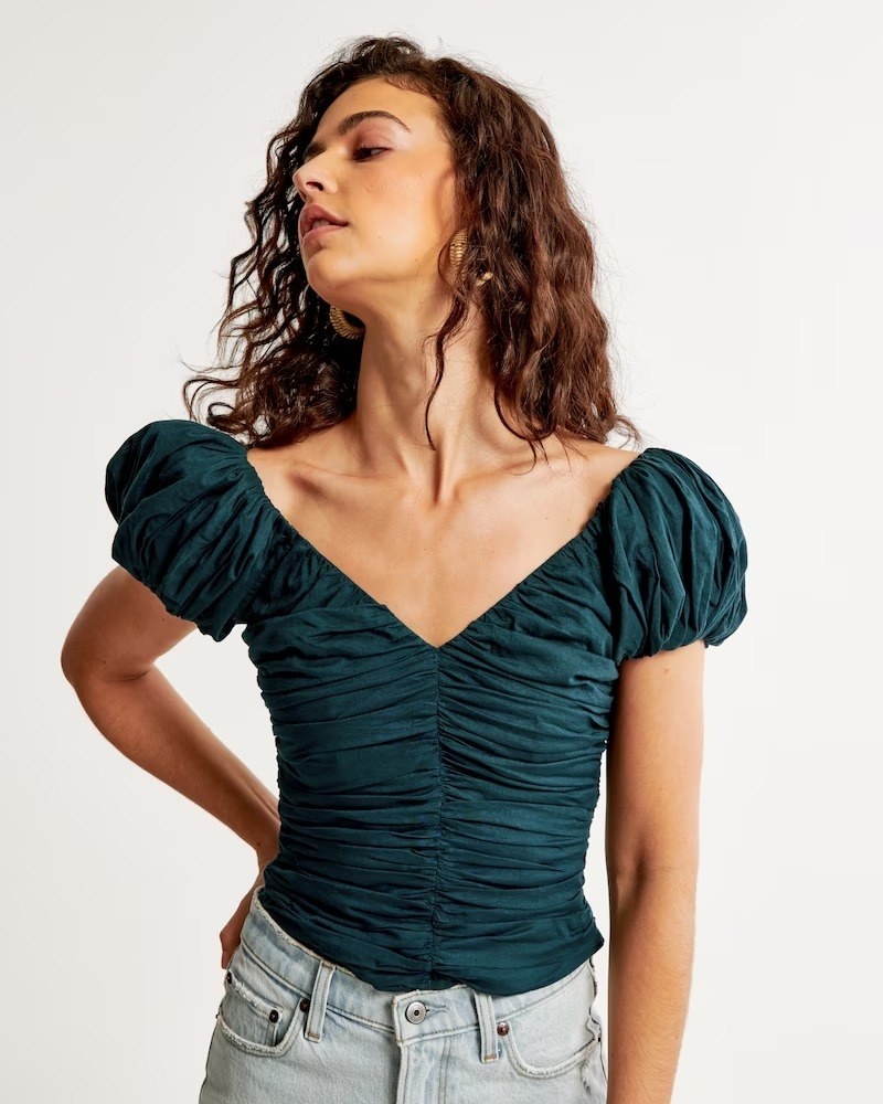 A model in the teal short sleeve top