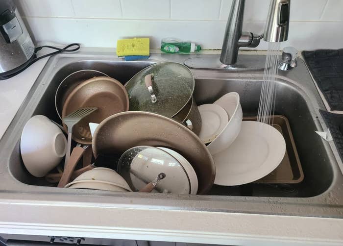 Kitchen sink full of dirty dishes