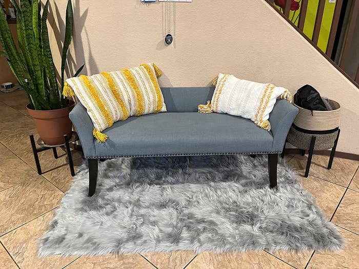 A reviewer&#x27;s photo of the gray area rug
