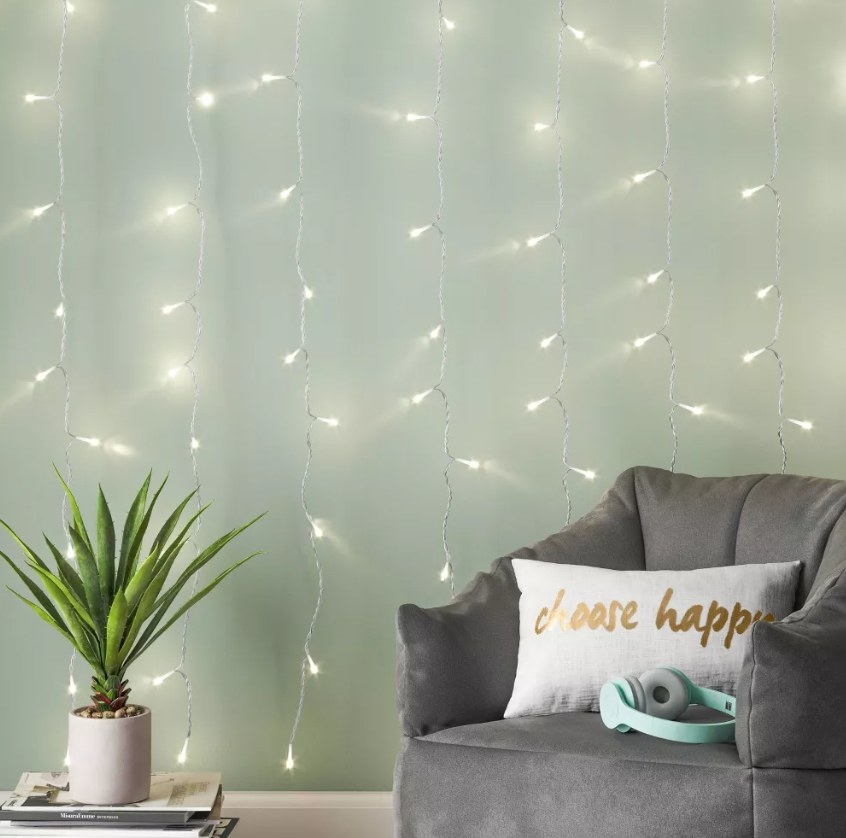 The fairy lights hung on a wall behind an armchair