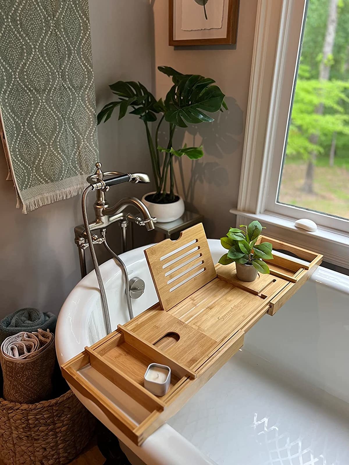 A reviewer&#x27;s photo of the bath caddy on the bath