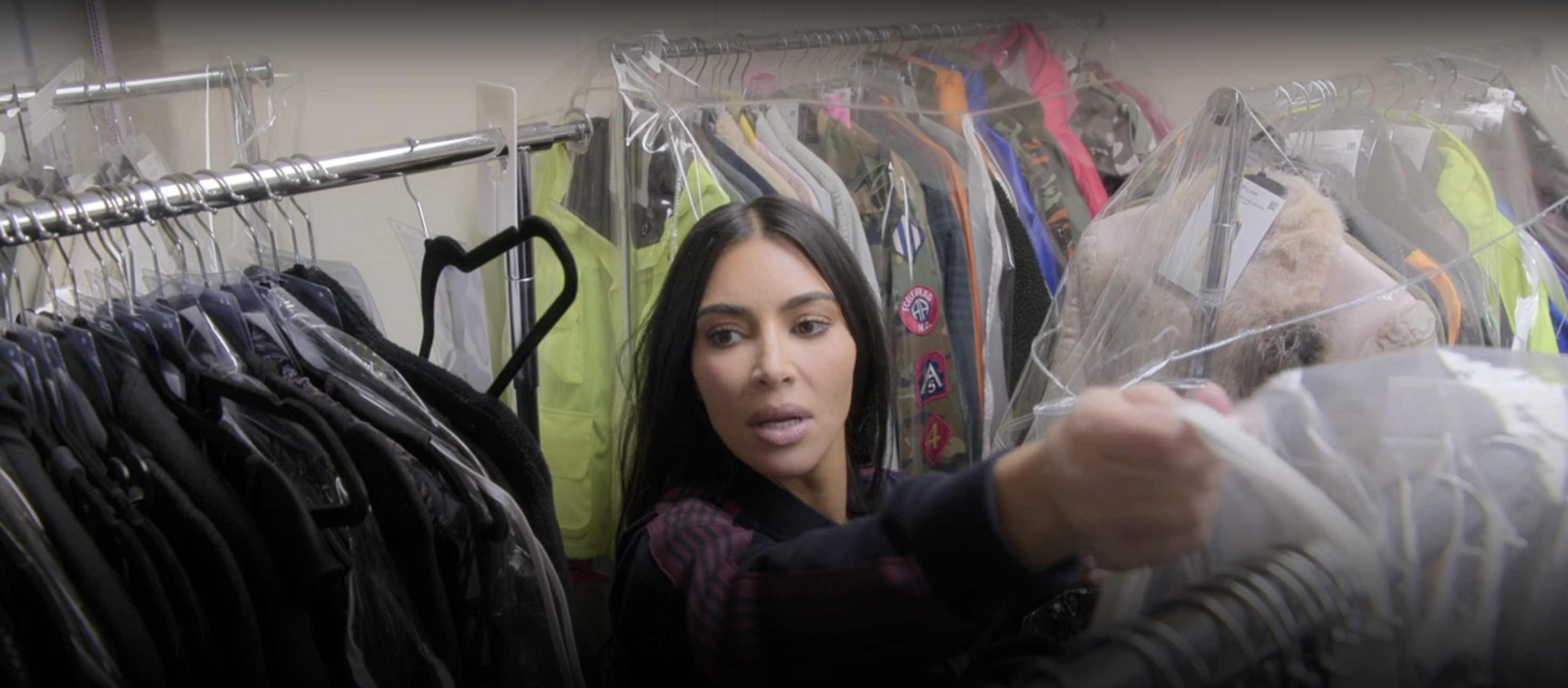 Kim Kardashian surrounded by her clothes