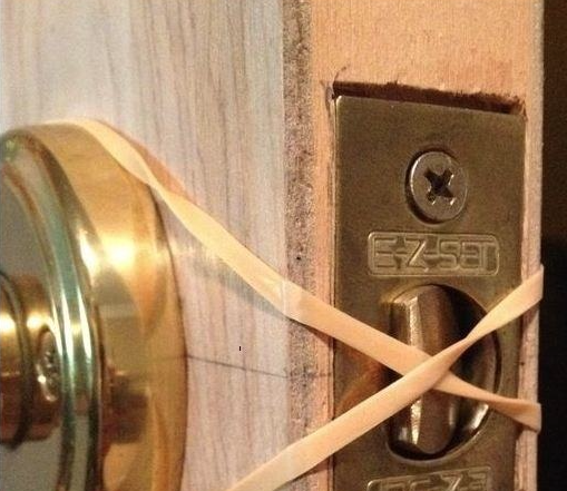 rubber band blocking the door latch