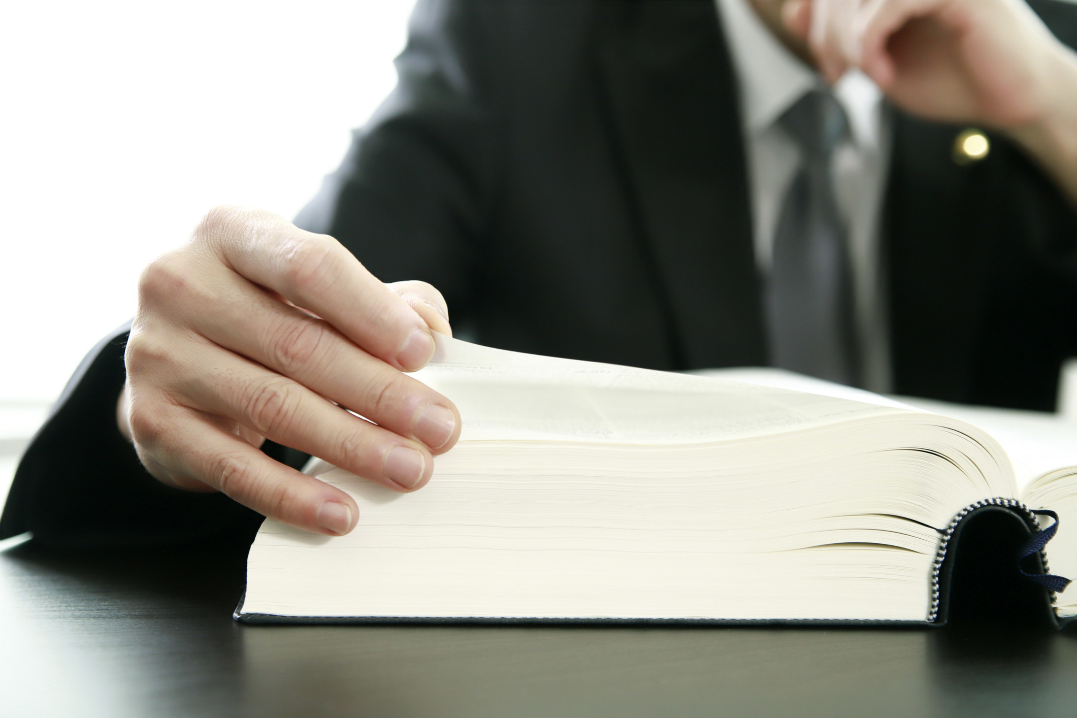 hand on an opened thick book