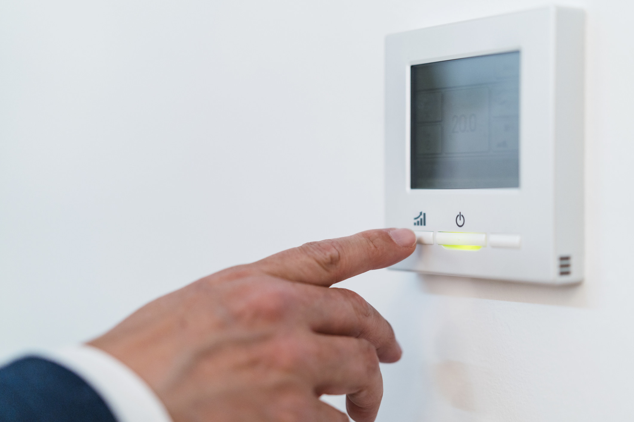 fingers changing the thermostat