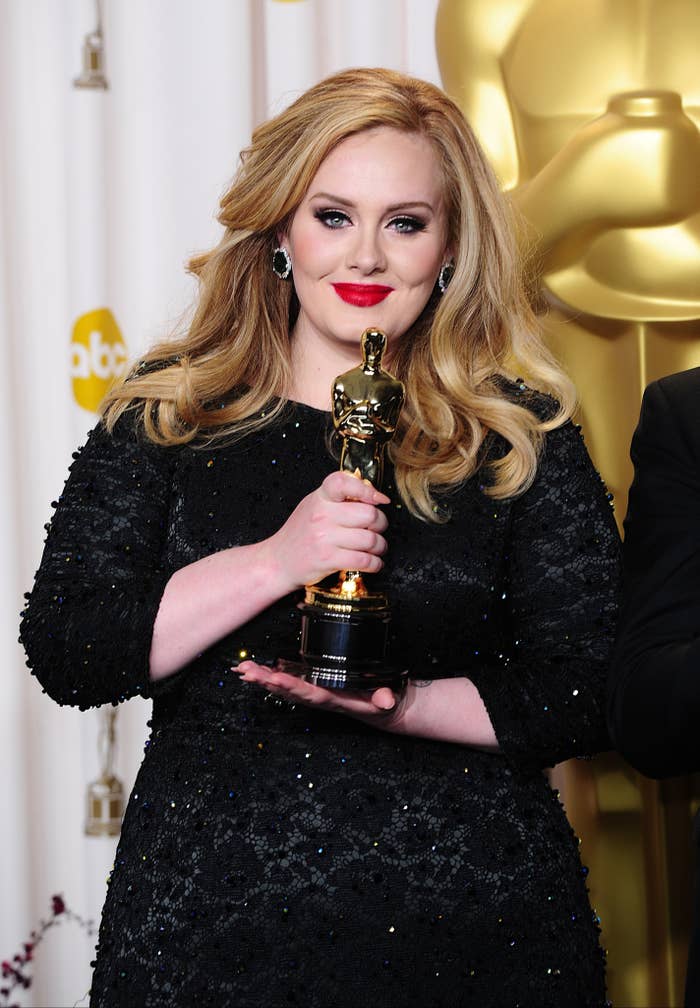 Adele holding her Oscar backstage
