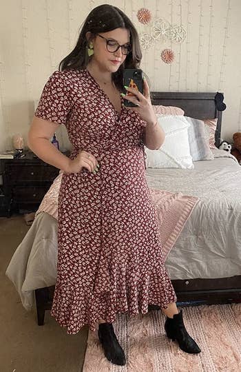 A reviewer with agelong brownish hairsbreadth wearing a agelong reddish wrapper formal with achromatic flowers connected it
