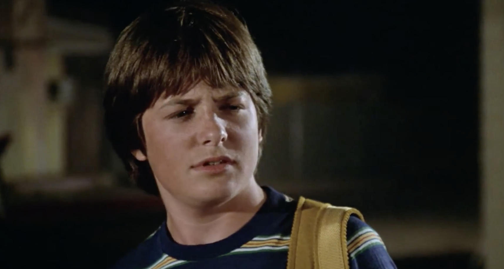 A closeup of a young Michael J. Fox, glaring and looking confused