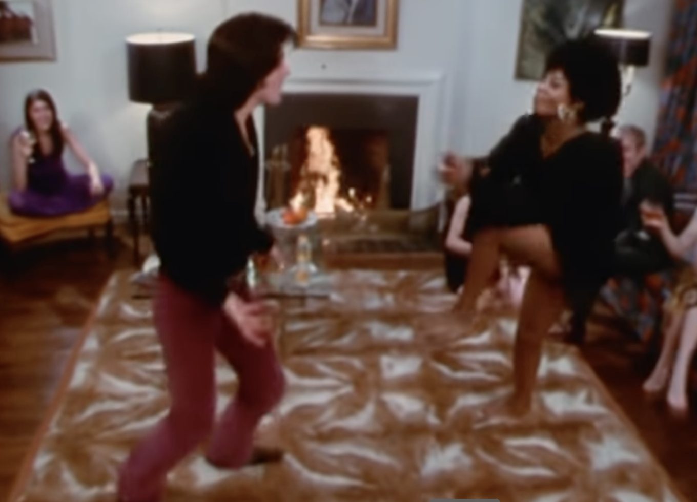 A screenshot of Sylvester Stallone dancing on a rug in a house that is the most 1970s setting you&#x27;ve ever seen