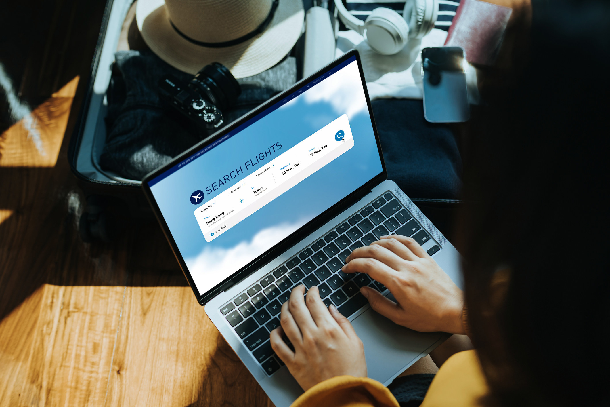 A woman searching for flights on laptop.