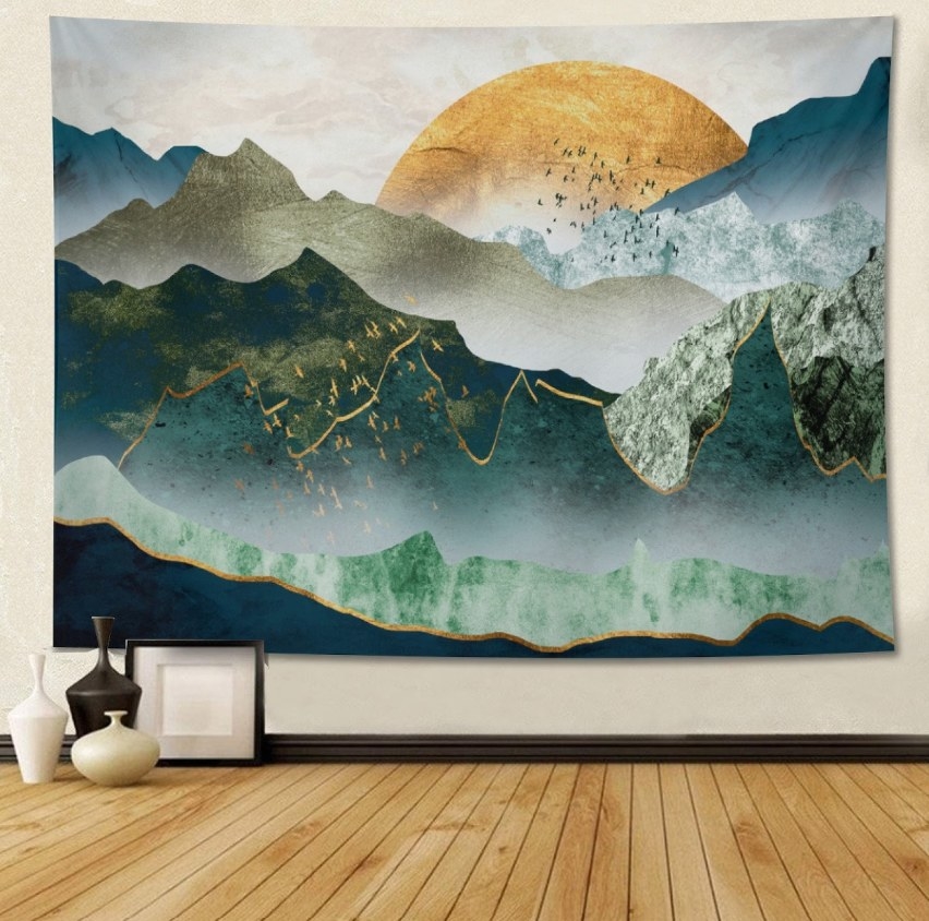 The large sunset tapestry hung on the wall