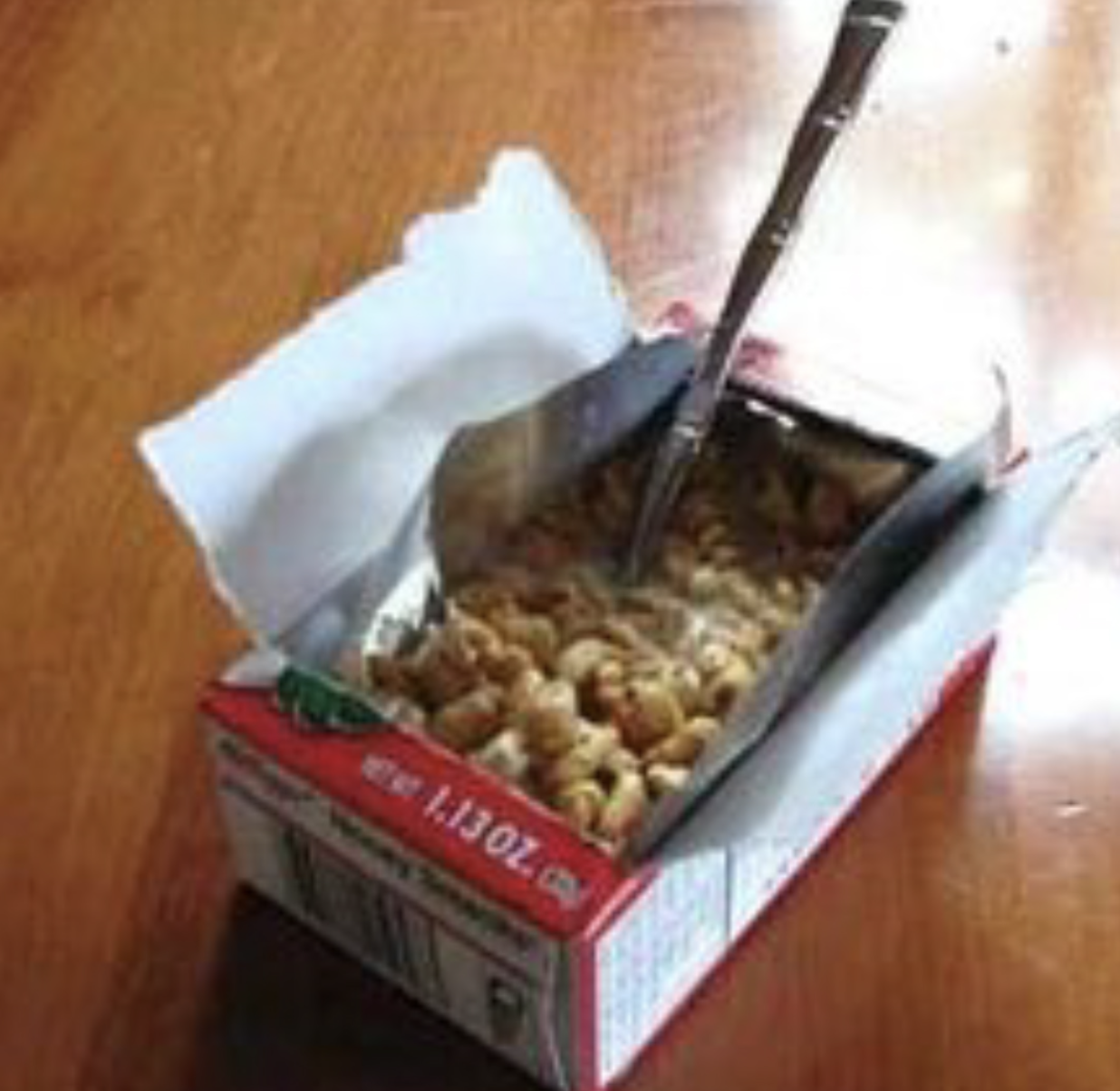 A single-serve cereal box from a variety pack with the front foil torn open