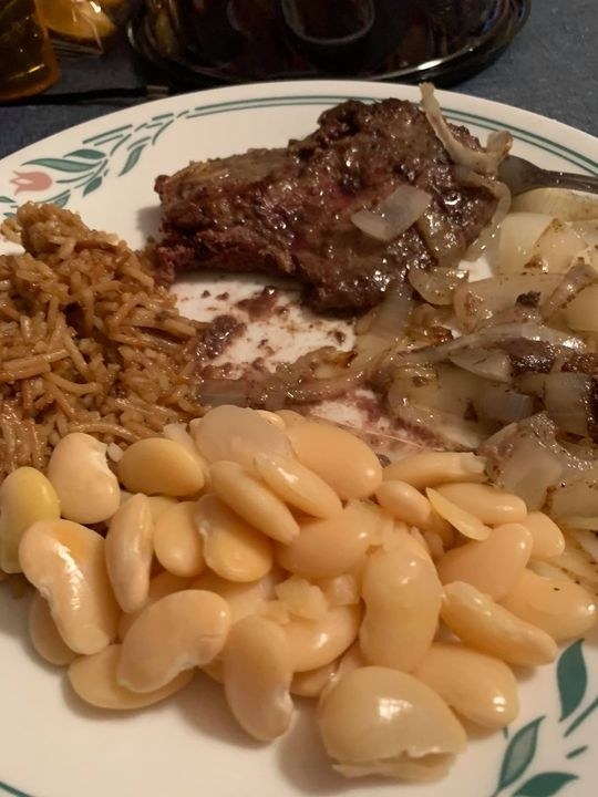 Liver, onions, lima beans, and rice on a plate