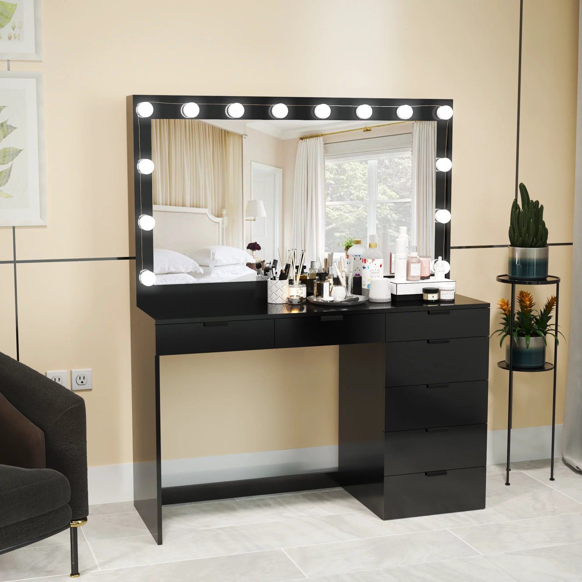 Black vanity with hollywood lights in a bedroom