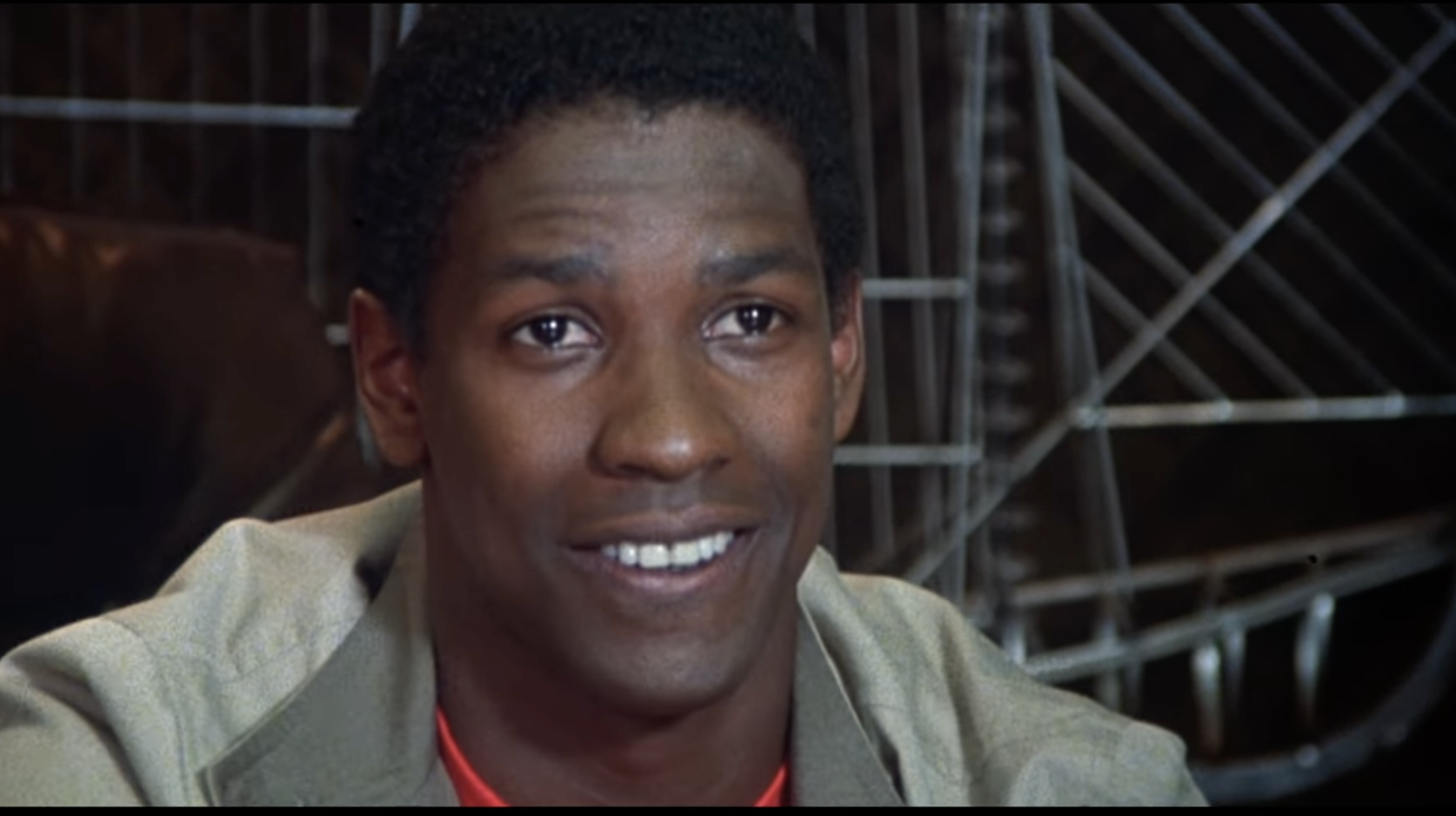 A screenshot of young Denzel Washington smiles at the camera