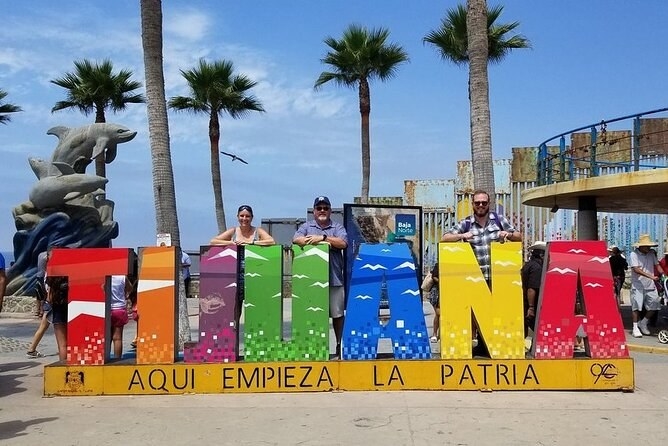 People posing in front of a Tijuana sign