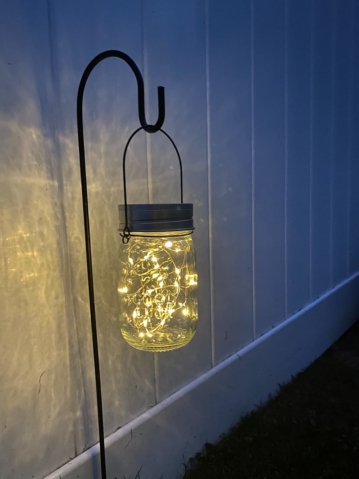 Reviewer image of the mason jar light in their backyard