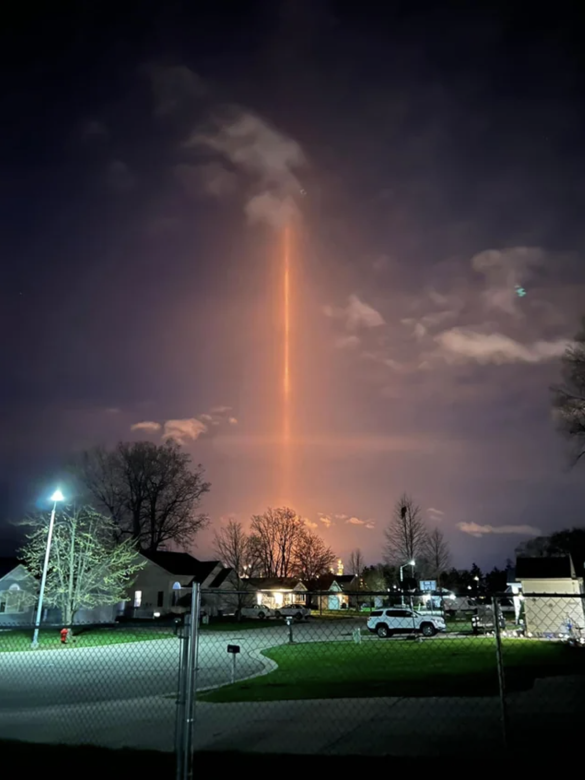 light beam seen from a suburban neighborhood
