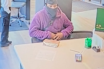 A suspect with a brick in a bank robbery