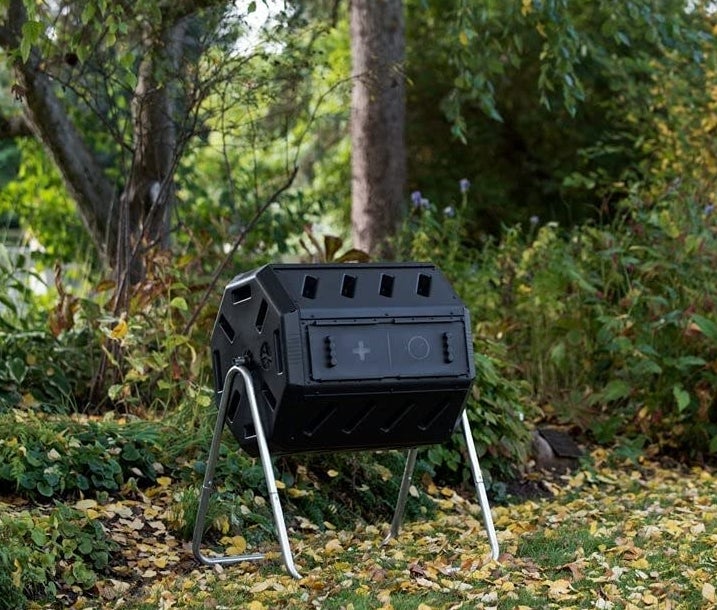 The composting tumbler in a backyard