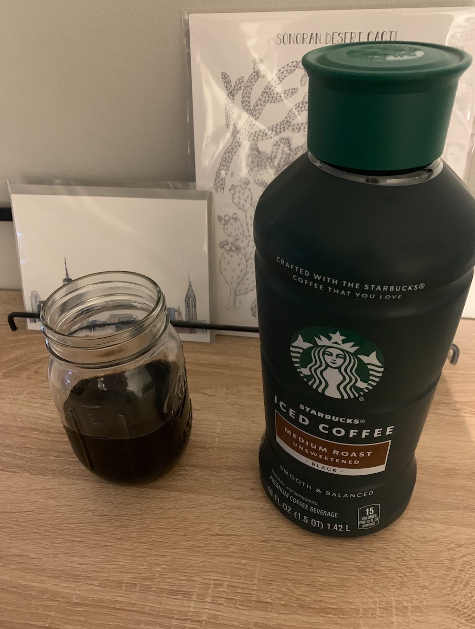 A Starbucks Iced Coffee jug alongside a Mason jar filled with iced coffee