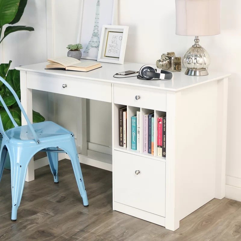 white desk with three drawers next to blue desk chair