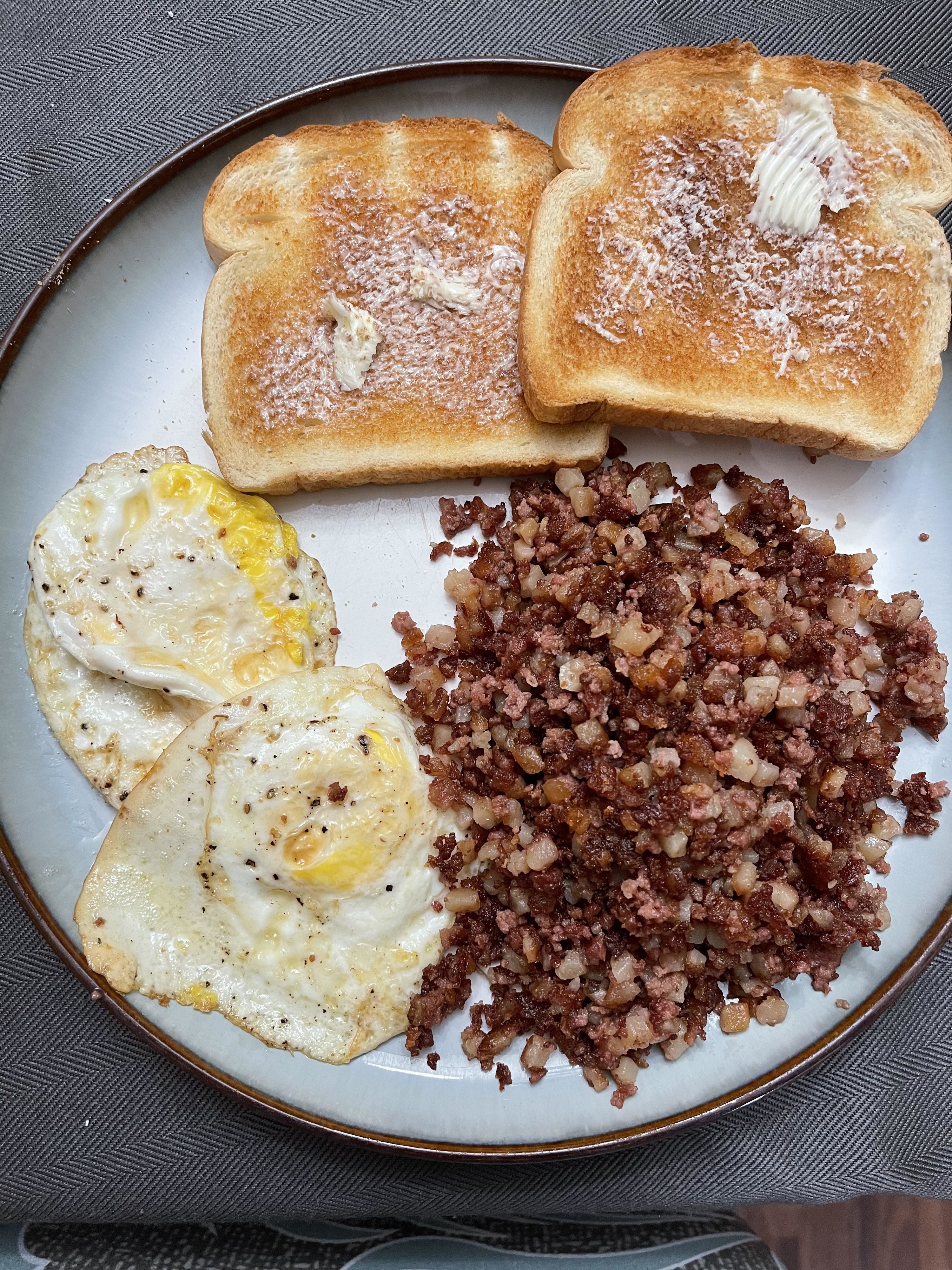 Corned beef hash, fried eggs, and toast