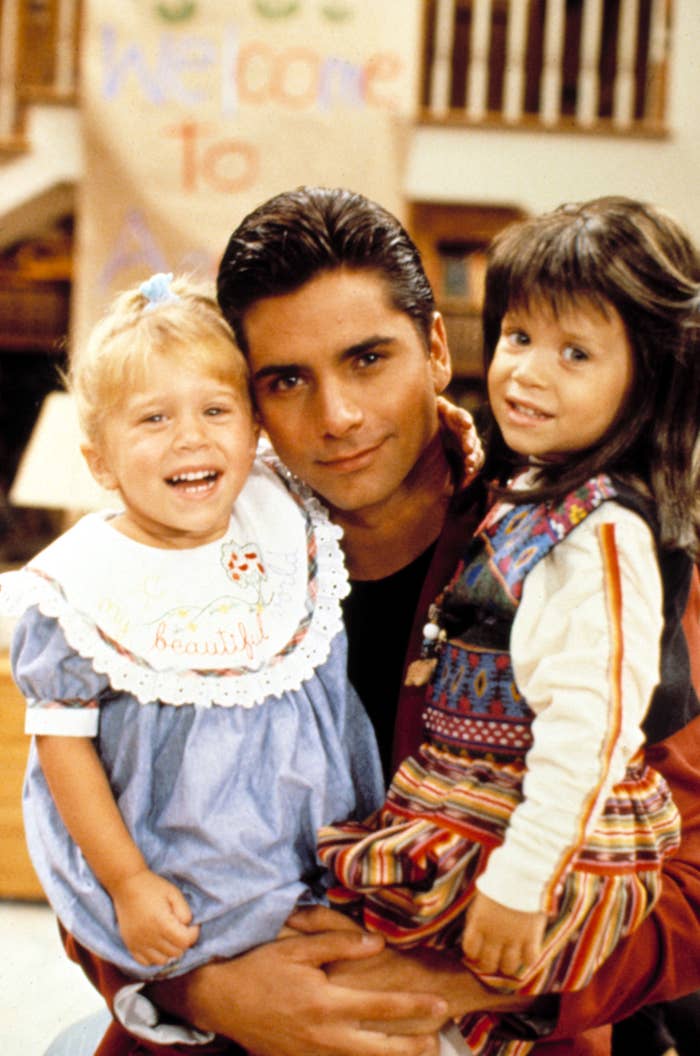 John Stamos holding the twins on the set of Full House