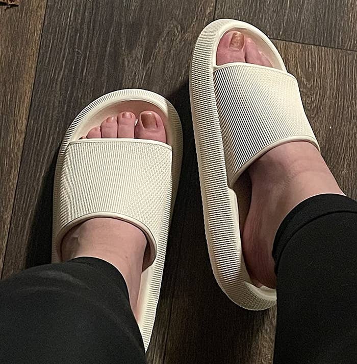 Reviewer wearing the cream slides without socks