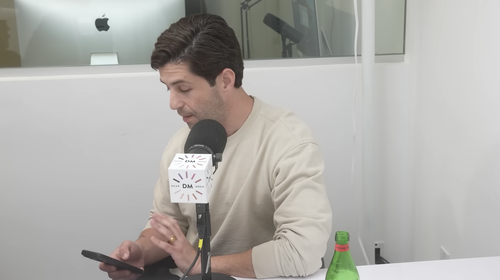A close-up of Josh Peck looking at his phone during the interview