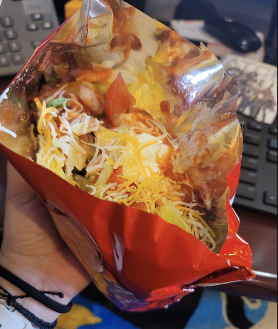 Doritos in a bag topped with taco garnishes