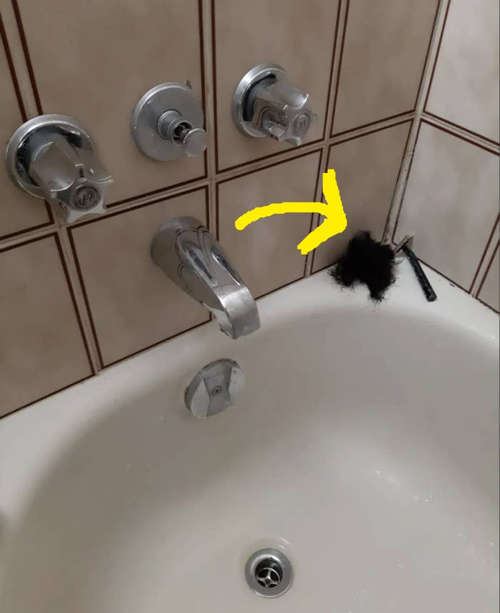 Large hair ball left in the corner of a shower