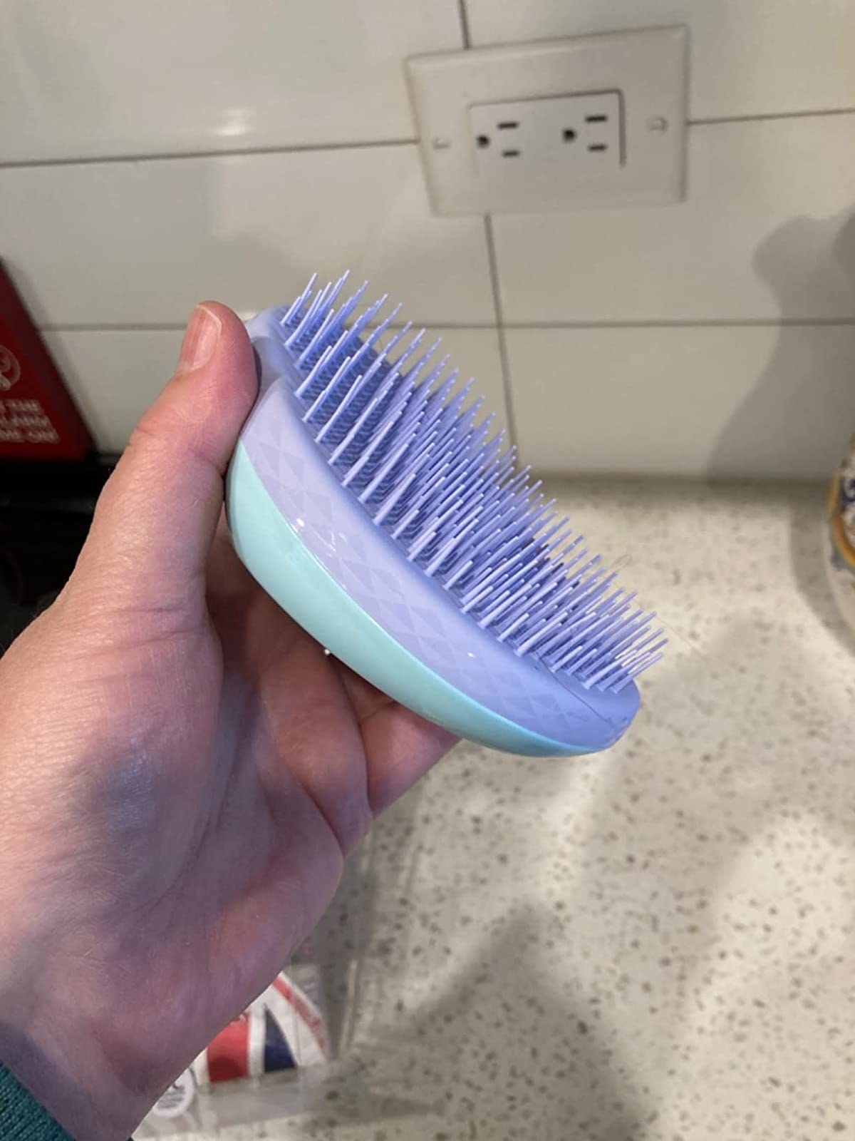 Reviewer holding the hair brush
