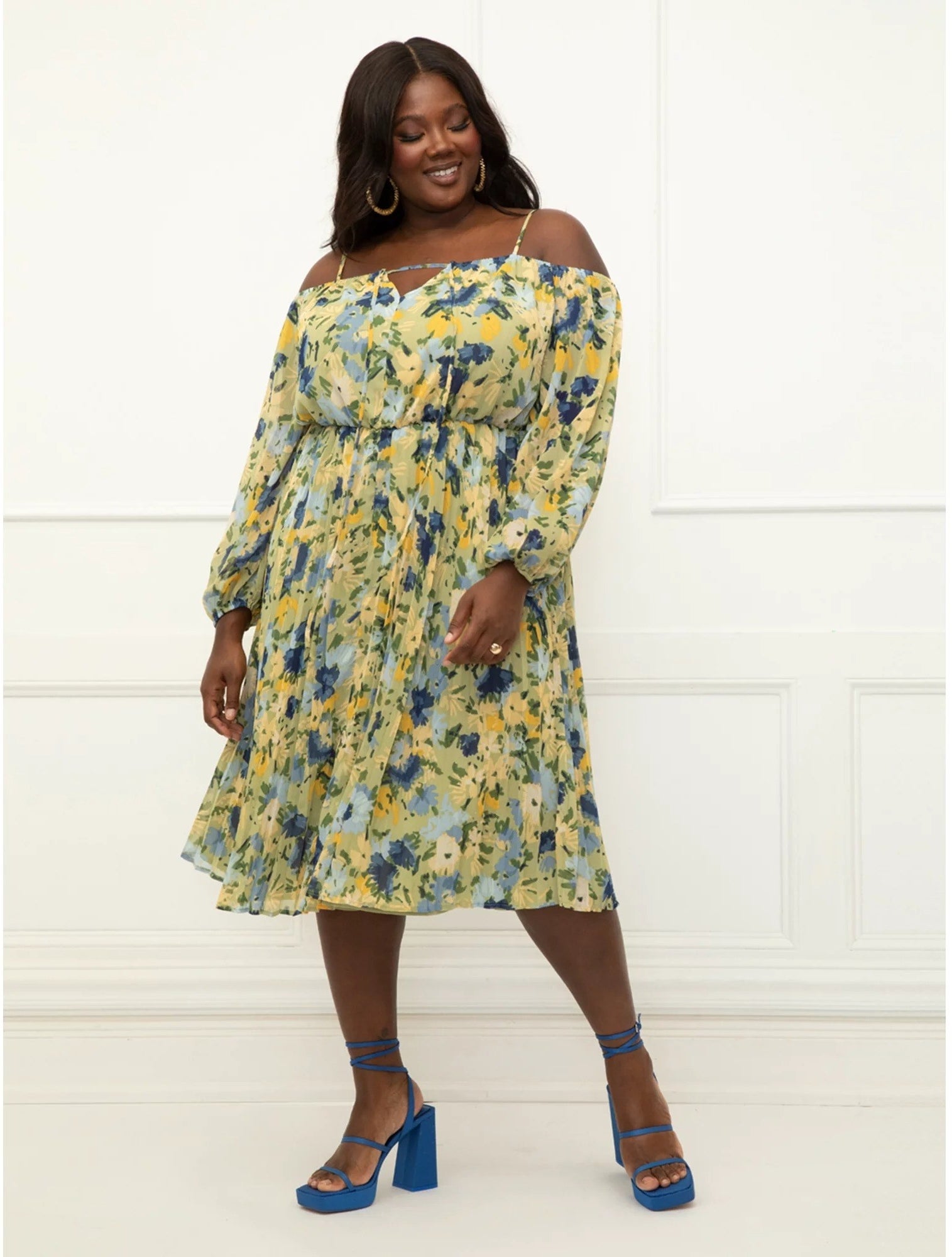 Model wears an off-the-shoulder dress